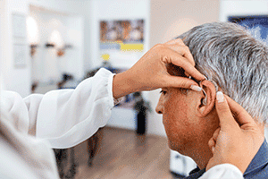 a man getting a hearing aid fitting in New York